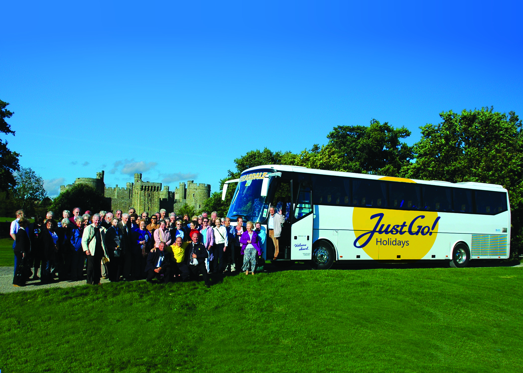 Group holiday standing alongside a Just Go! Holidays coach